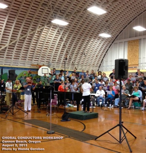 Me, conducting the dress rehearsal on the day of performance with violin, percussionists, soloist, and choir. Half of the choir and the soloist are not pictured. Cannon Beach School Gymnasium, Oregon.