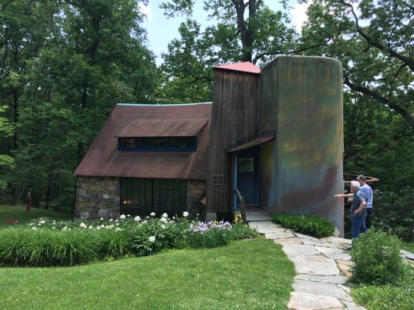 Stone, wood, and stucco comprise three sections of the artist's studio built in increments as they were needed.